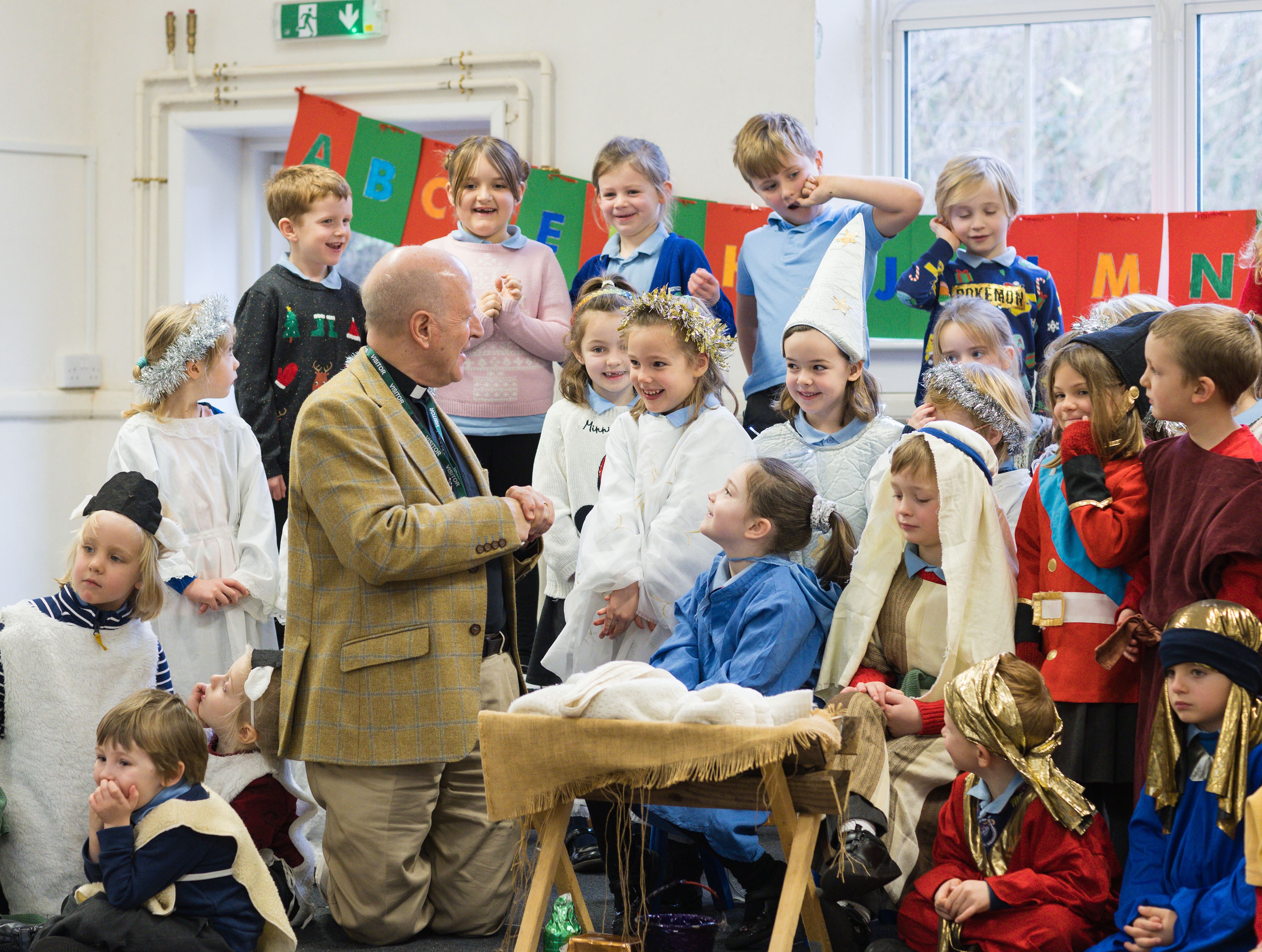 Bishop Martin surrounded by children at the school nativity