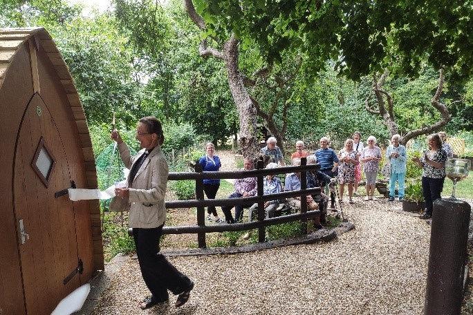 A group of villagers celebrating the community garden, with Revd Manette unveiling the new eco-toilet