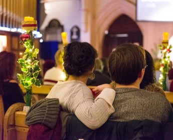 Christmas view of inside a church with the backs of two people's head