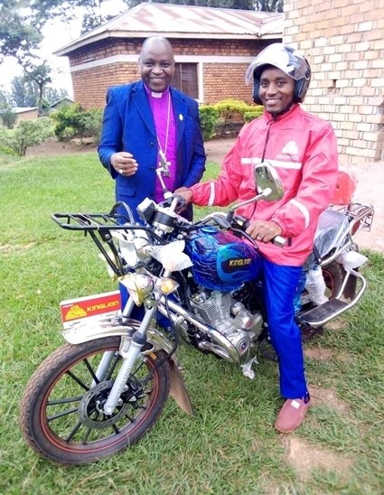 Bishop with a priest on a motor bike