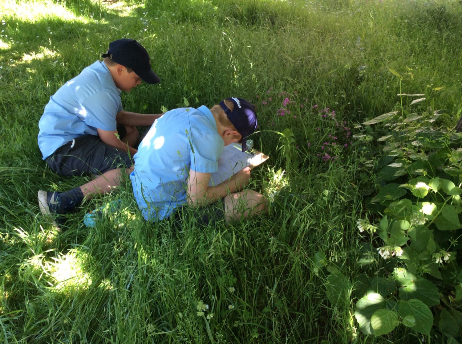 Two school boys investigate the churchyard for creatures