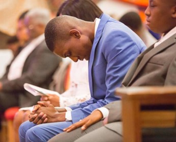 Man praying in the pews